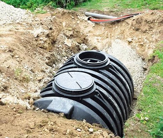 Underground septic tank installation in excavated pit